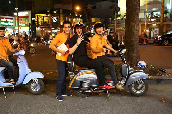 Zip around Ho Chi Minh City on a Vespa at night